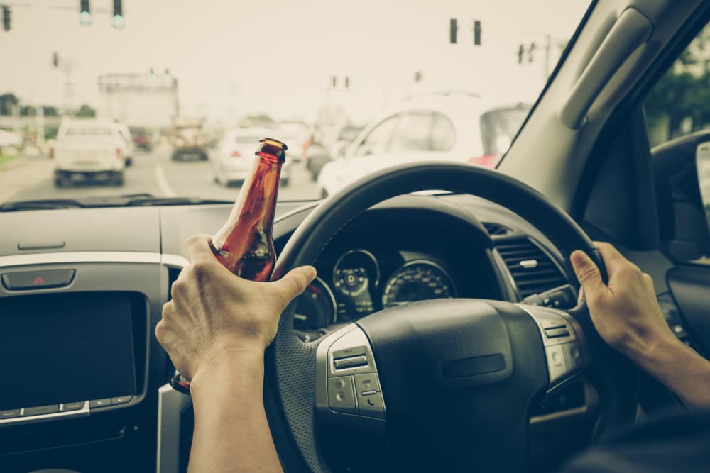 A man driving a car under the influence of alcohol