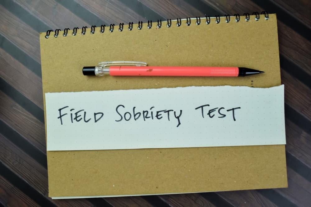 Field Sobriety Test write on sticky notes isolated on Wooden Table.