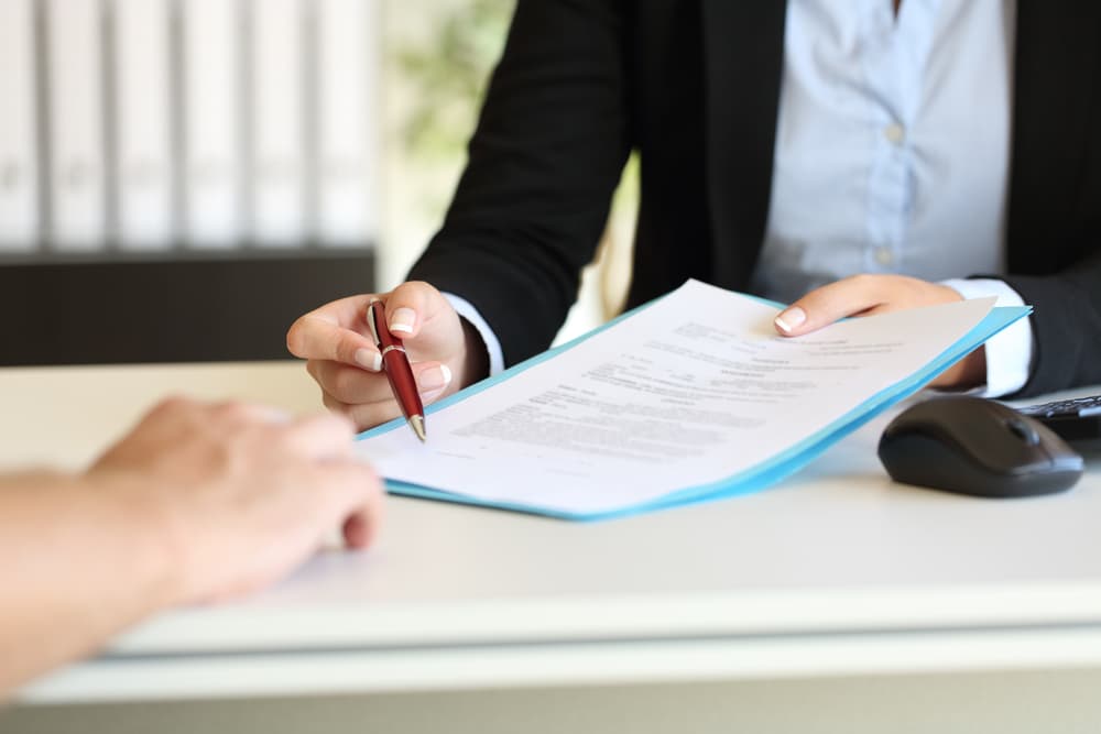 A man submitting a paper for signature 