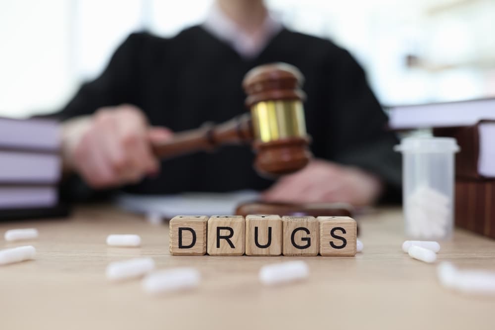 blocks spell 'drugs' in front of judge with gavel